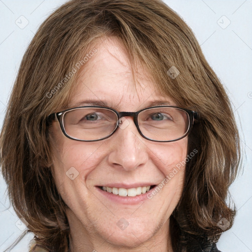 Joyful white adult female with long  brown hair and blue eyes