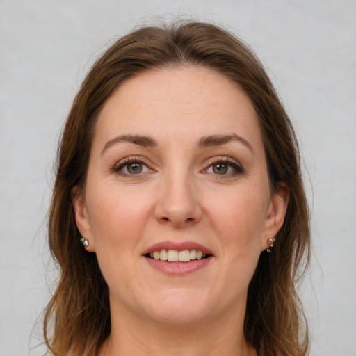 Joyful white young-adult female with medium  brown hair and green eyes