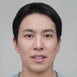 Joyful asian young-adult male with short  black hair and brown eyes