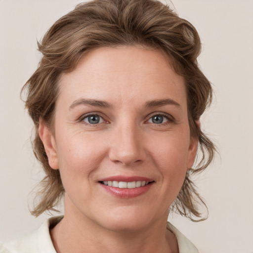 Joyful white young-adult female with medium  brown hair and blue eyes