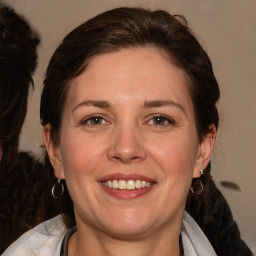 Joyful white adult female with medium  brown hair and brown eyes