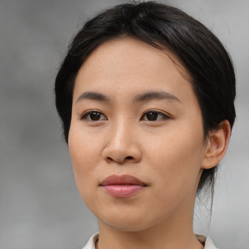 Joyful asian young-adult female with medium  brown hair and brown eyes