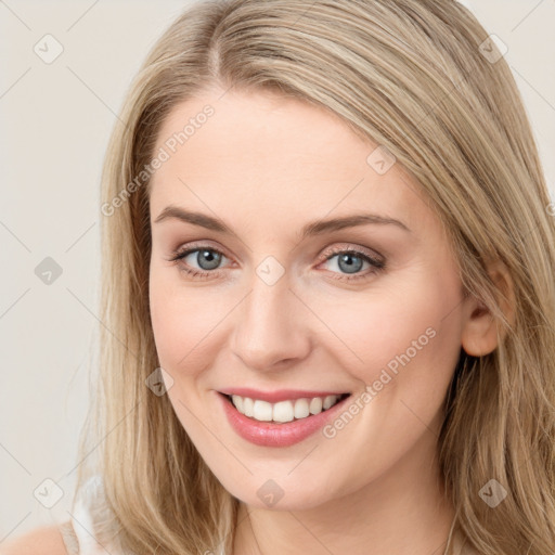 Joyful white young-adult female with long  brown hair and blue eyes