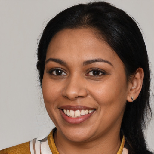 Joyful latino young-adult female with medium  black hair and brown eyes