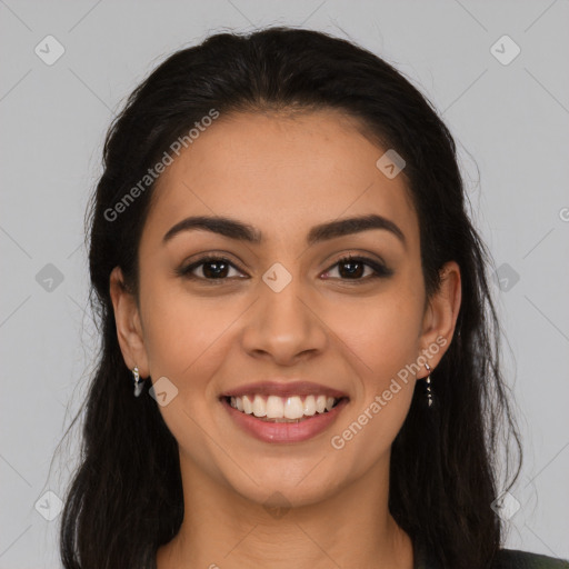 Joyful latino young-adult female with long  brown hair and brown eyes