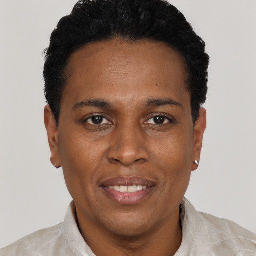 Joyful black adult female with short  black hair and brown eyes