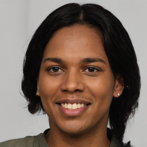 Joyful black young-adult female with medium  black hair and brown eyes