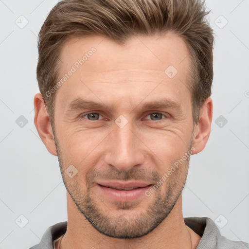 Joyful white adult male with short  brown hair and grey eyes