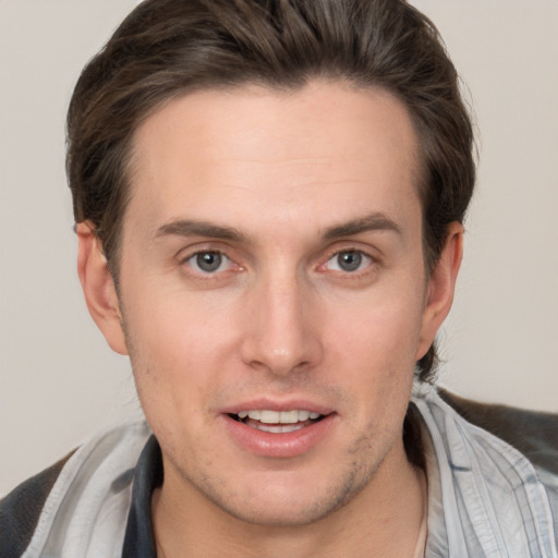 Joyful white young-adult male with short  brown hair and brown eyes