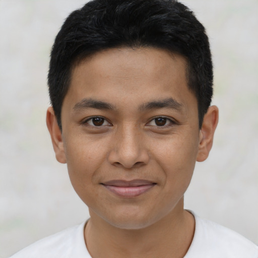Joyful latino young-adult male with short  brown hair and brown eyes