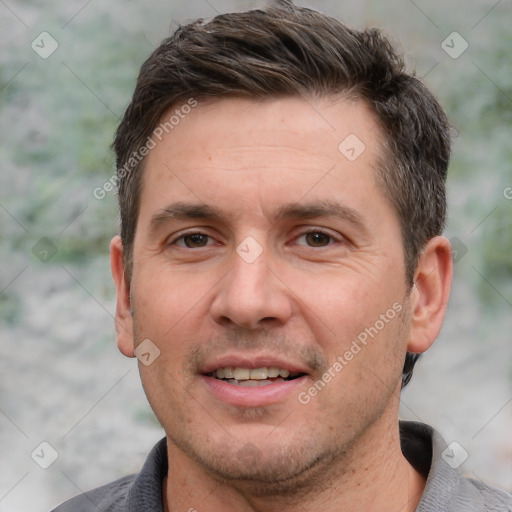 Joyful white adult male with short  brown hair and brown eyes