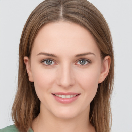 Joyful white young-adult female with long  brown hair and grey eyes