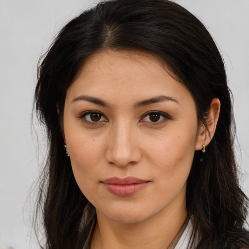 Joyful latino young-adult female with long  brown hair and brown eyes
