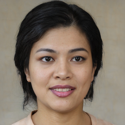 Joyful asian young-adult female with medium  black hair and brown eyes