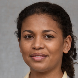 Joyful black adult female with short  brown hair and brown eyes