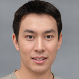 Joyful asian young-adult male with short  brown hair and brown eyes