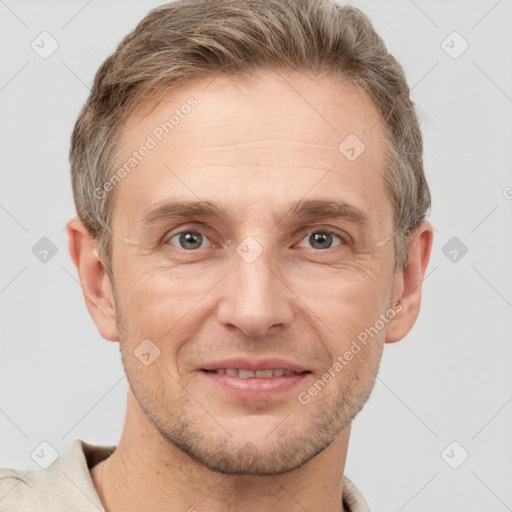 Joyful white adult male with short  brown hair and grey eyes