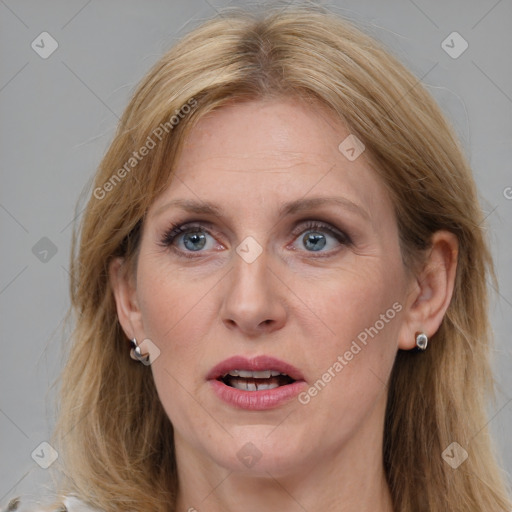 Joyful white adult female with medium  brown hair and blue eyes