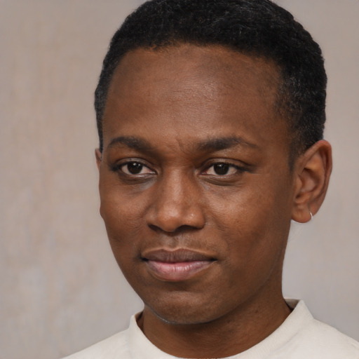 Joyful black young-adult male with short  black hair and brown eyes