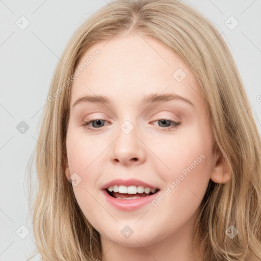 Joyful white young-adult female with long  brown hair and blue eyes