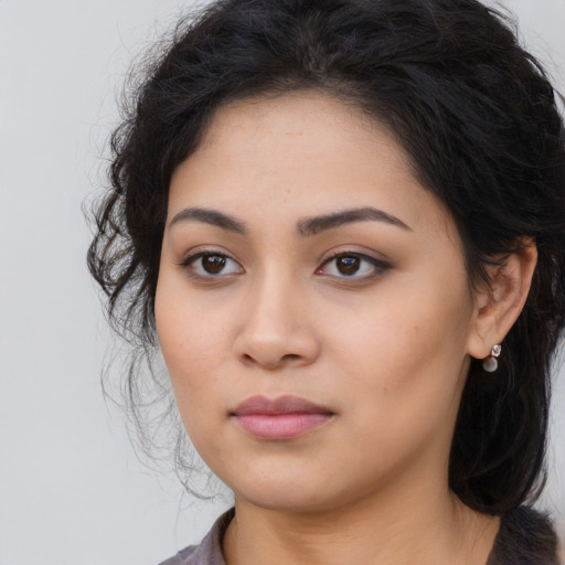 Joyful latino young-adult female with long  black hair and brown eyes