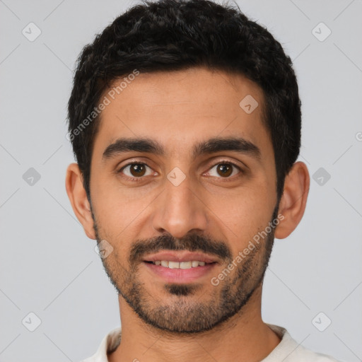 Joyful latino young-adult male with short  black hair and brown eyes