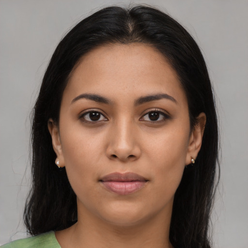 Joyful latino young-adult female with long  brown hair and brown eyes