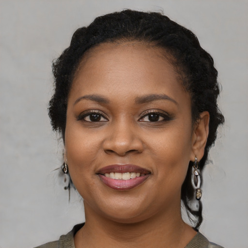 Joyful black young-adult female with medium  black hair and brown eyes