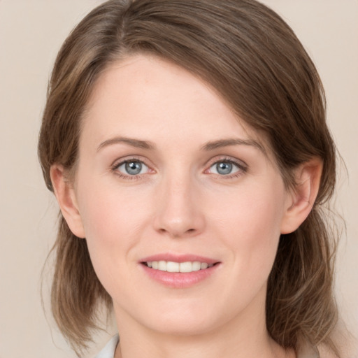 Joyful white young-adult female with medium  brown hair and grey eyes