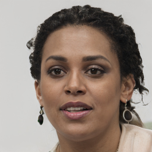 Joyful black young-adult female with short  brown hair and brown eyes