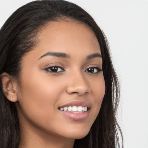 Joyful latino young-adult female with long  brown hair and brown eyes