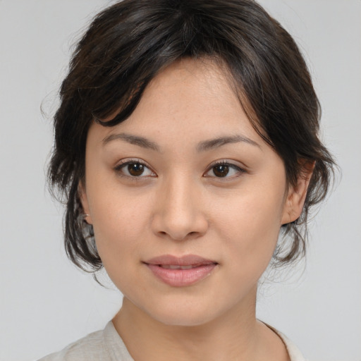 Joyful asian young-adult female with medium  brown hair and brown eyes