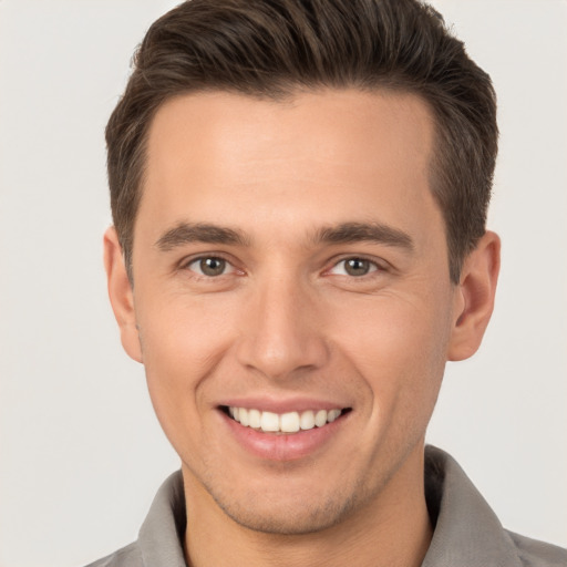 Joyful white young-adult male with short  brown hair and brown eyes