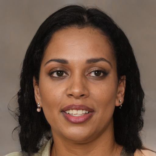 Joyful black adult female with medium  brown hair and brown eyes