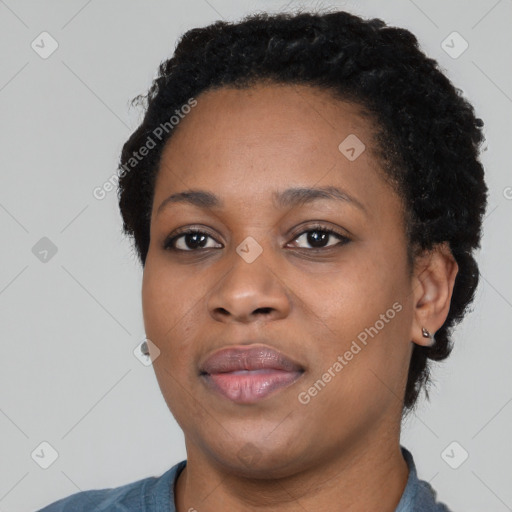 Joyful black young-adult female with short  black hair and brown eyes