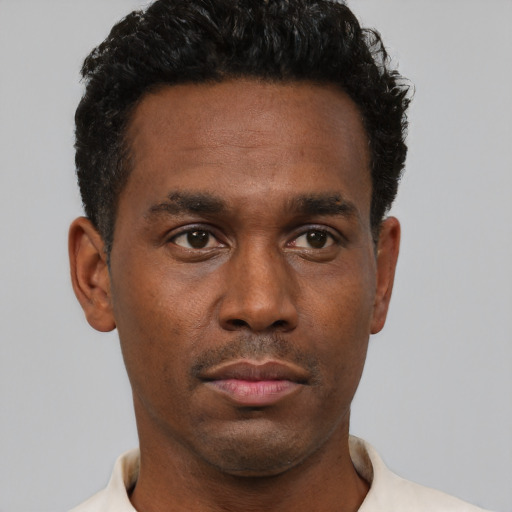 Neutral black young-adult male with short  black hair and brown eyes