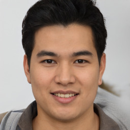 Joyful asian young-adult male with short  brown hair and brown eyes