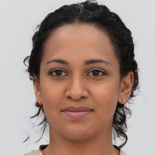 Joyful latino young-adult female with medium  brown hair and brown eyes
