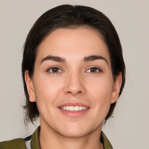 Joyful white young-adult female with medium  brown hair and brown eyes