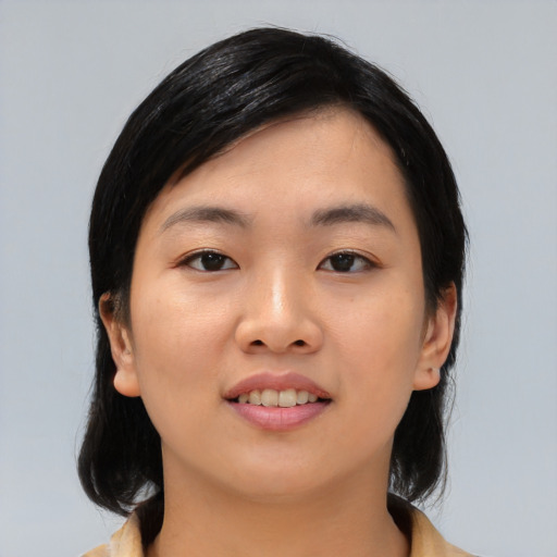 Joyful asian young-adult female with medium  black hair and brown eyes