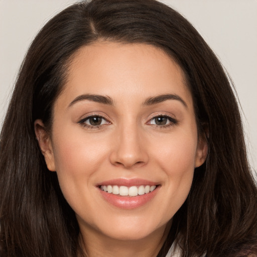 Joyful white young-adult female with long  brown hair and brown eyes