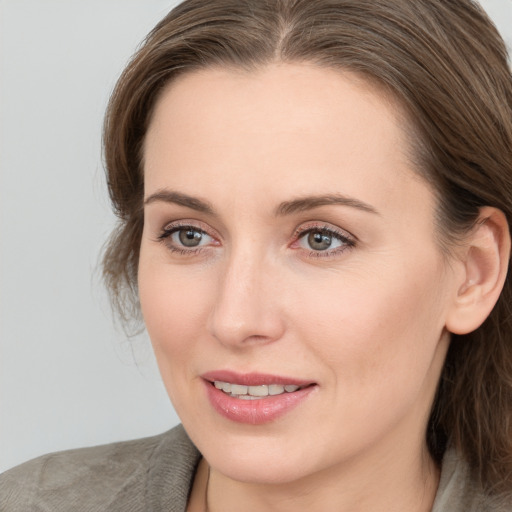 Joyful white young-adult female with medium  brown hair and blue eyes