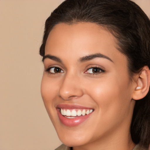 Joyful white young-adult female with long  brown hair and brown eyes