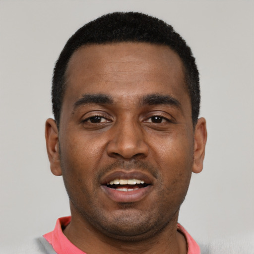 Joyful black young-adult male with short  black hair and brown eyes