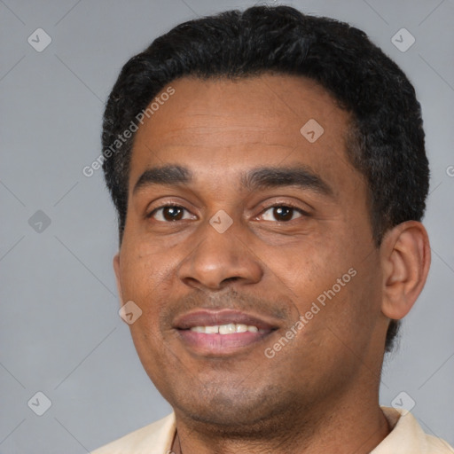 Joyful black young-adult male with short  black hair and brown eyes