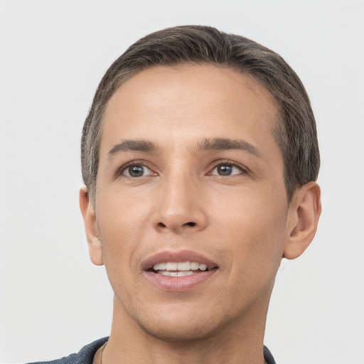 Joyful white young-adult male with short  brown hair and brown eyes