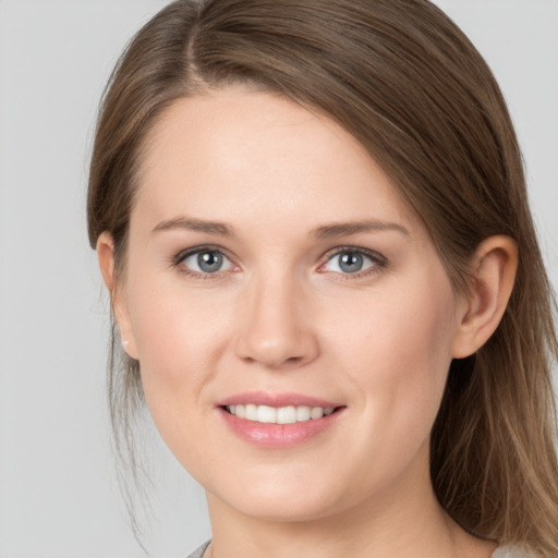 Joyful white young-adult female with long  brown hair and grey eyes