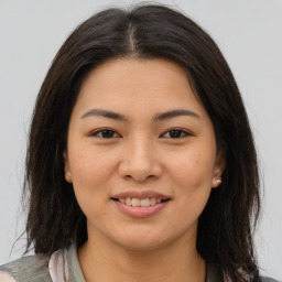 Joyful asian young-adult female with medium  brown hair and brown eyes