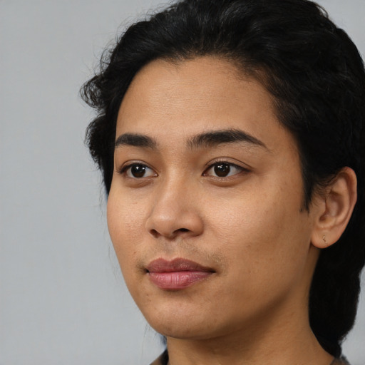 Joyful black young-adult female with medium  black hair and brown eyes