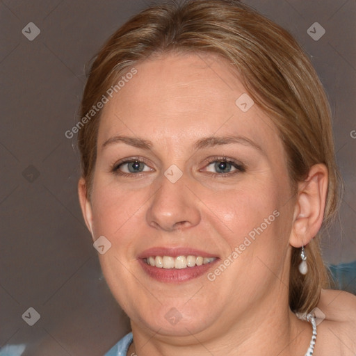 Joyful white adult female with medium  brown hair and blue eyes